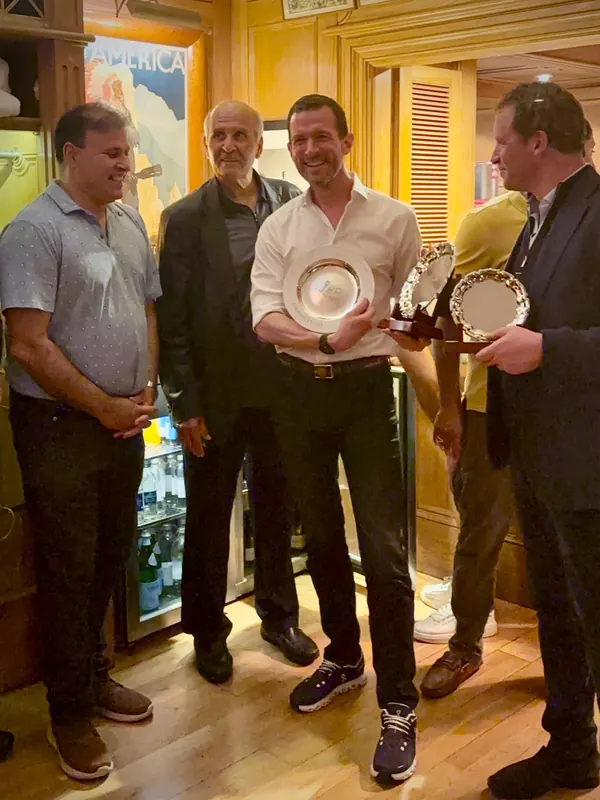 Paul Fagan holding his Andros Cup B Plate, with Hiddy Jahan and Zubair Khan beside him.